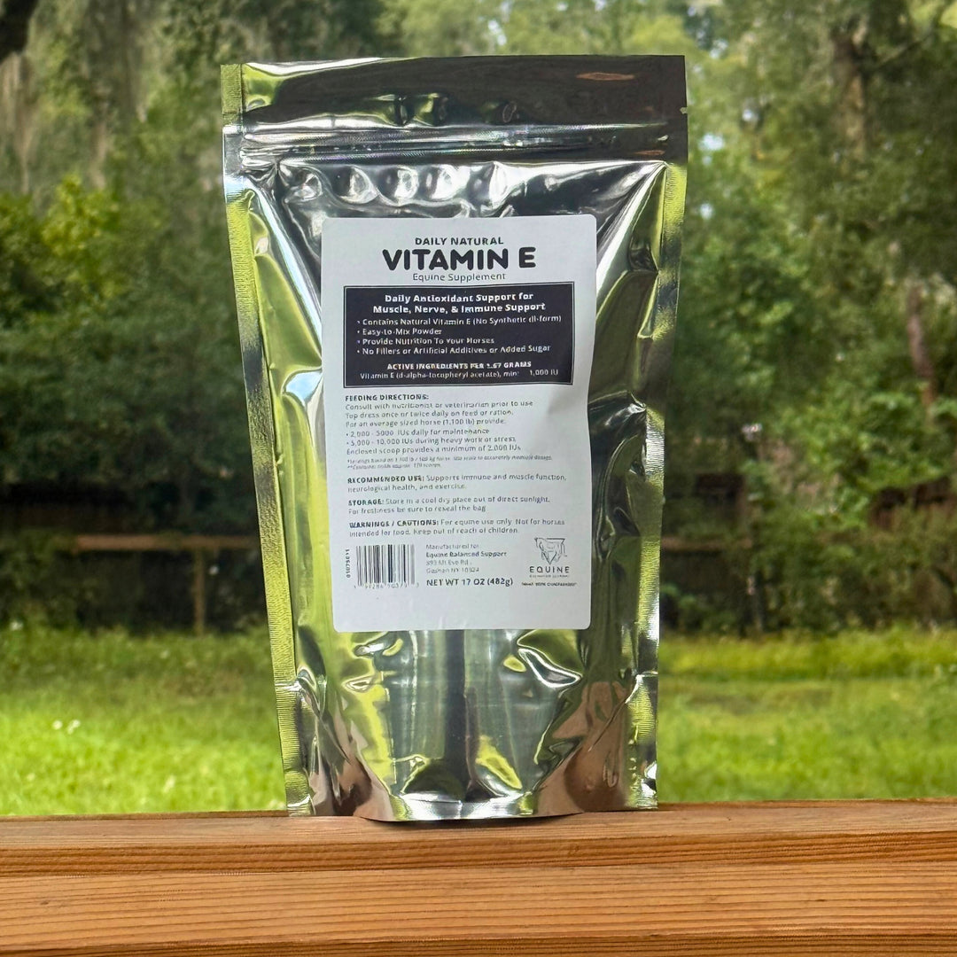 Vitamin E supplement package on a wooden surface with a natural background