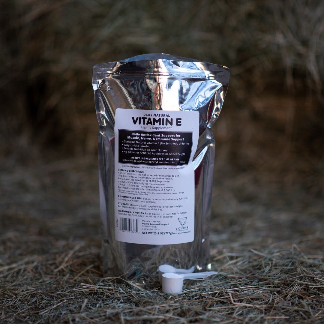 Natural E supplement package on a hay background