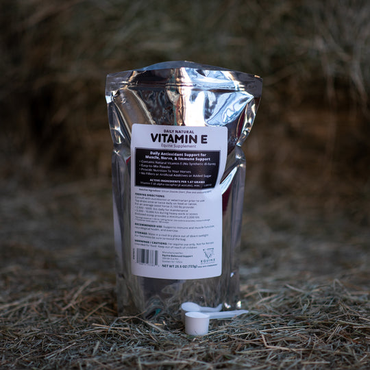 Natural E supplement package on a hay background